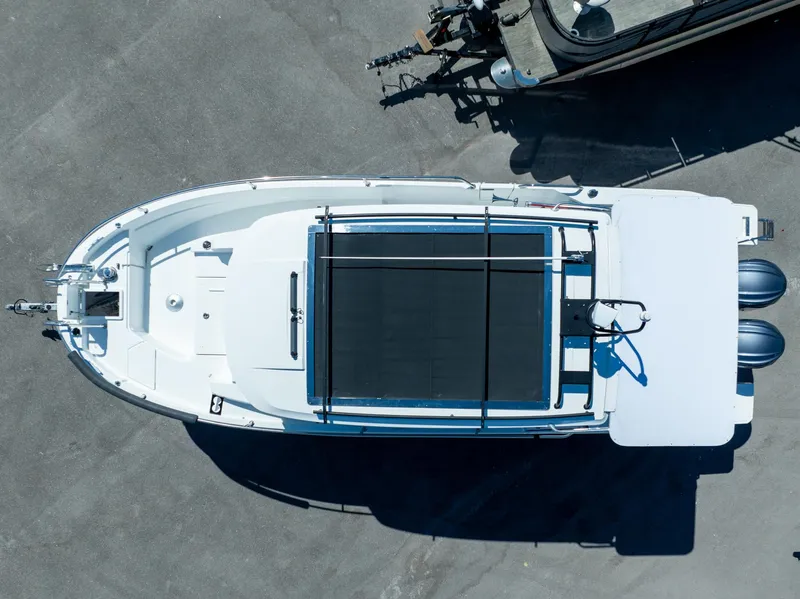 Slide: The Image of 2022 Jeanneau NC Sport 895 boat, aerial view, docked with twin engines. - 8