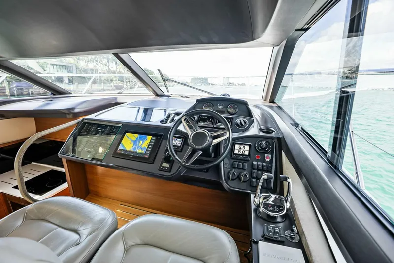 Slide: The Image of 2019 Princess 43 Flybridge yacht cockpit with modern navigation equipment and leather seating. - 11