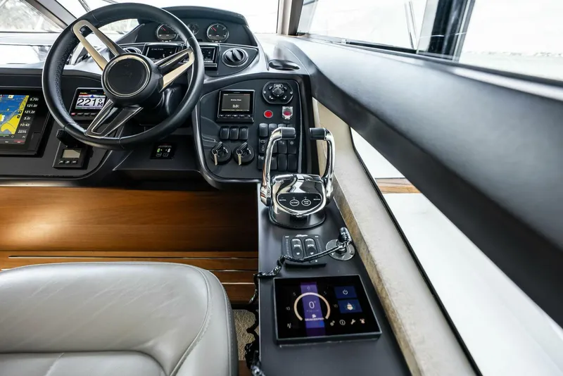 Slide: The Image of Interior helm of 2019 Princess 43 Flybridge yacht with modern controls and steering wheel. - 12