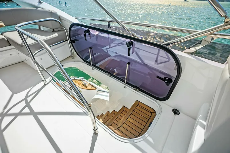 Slide: The Image of 2019 Princess 43 Flybridge yacht with open hatch and wooden steps, overlooking the sea. - 34