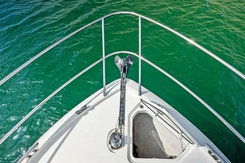 Slide: The Image of Bow view of 2019 Princess 43 Flybridge yacht on clear green water. - 36