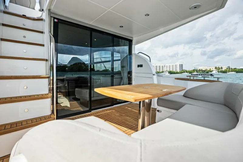 Slide: The Image of 2019 Princess 43 Flybridge yacht with outdoor seating and wooden table. - 42