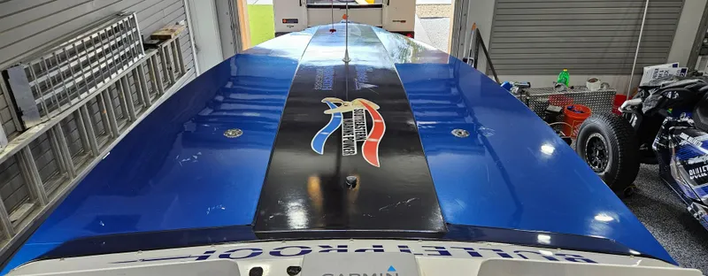 Slide: The Image of 2003 Ultimate Warlock 29 World Class Offshore Race boat in a garage. - 17