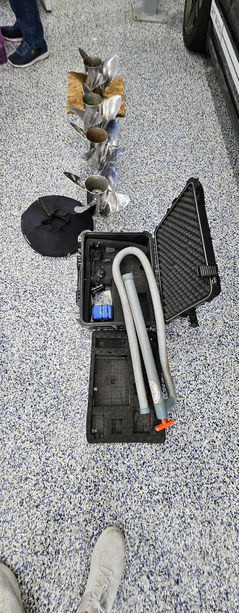 Slide: The Image of Open toolbox with hoses and metal parts on speckled floor, related to 2003 Ultimate Warlock boat. - 22