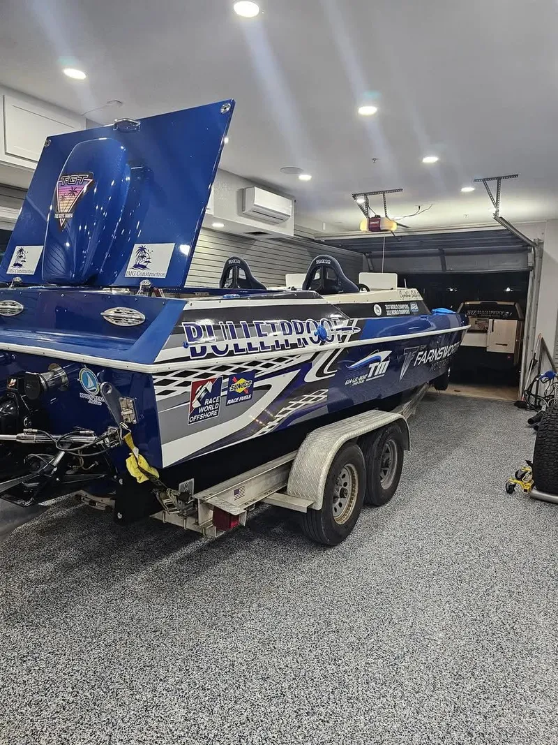 Slide: The Image of 2003 Ultimate Warlock 29 World Class Offshore Race boat in a garage on a trailer. - 26