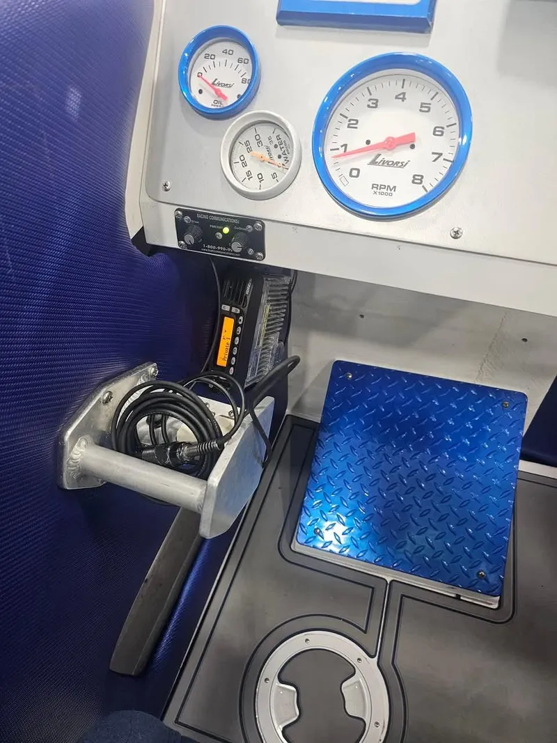 Slide: The Image of Dashboard of 2003 Ultimate Warlock 29 World Class Offshore Race boat with gauges and controls. - 32