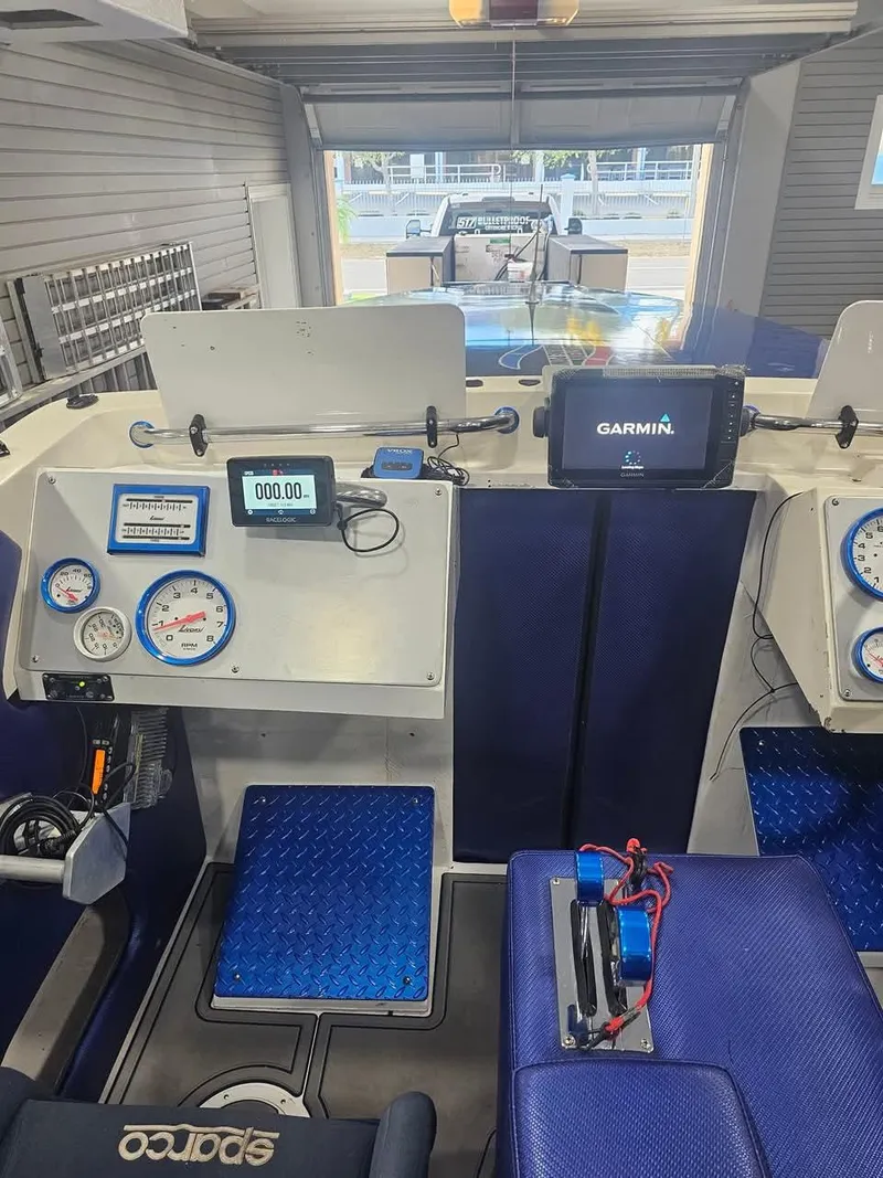Slide: The Image of Interior of a 2003 Ultimate Warlock 29 World Class Offshore Race boat with navigation equipment. - 36