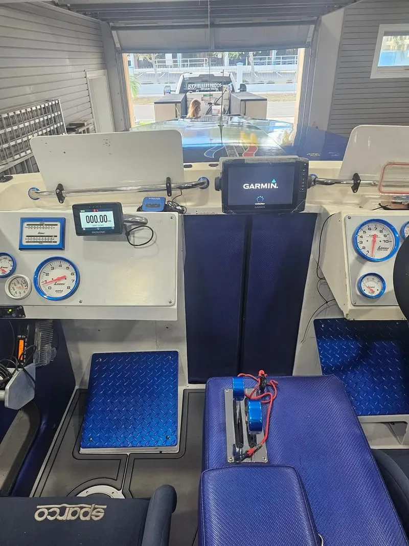 Slide: The Image of Interior of a 2003 Ultimate Warlock 29 World Class Offshore Race boat with modern gauges and controls. - 37