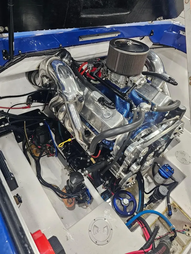 Slide: The Image of Engine of a 2003 Ultimate Warlock 29 World Class Offshore Race boat, showcasing polished components. - 39