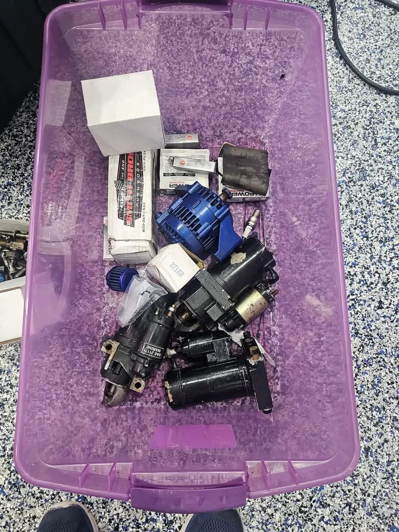 Slide: The Image of Purple storage bin with various mechanical parts for a 2003 Ultimate Warlock 29 World Class Offshore Race boat. - 43