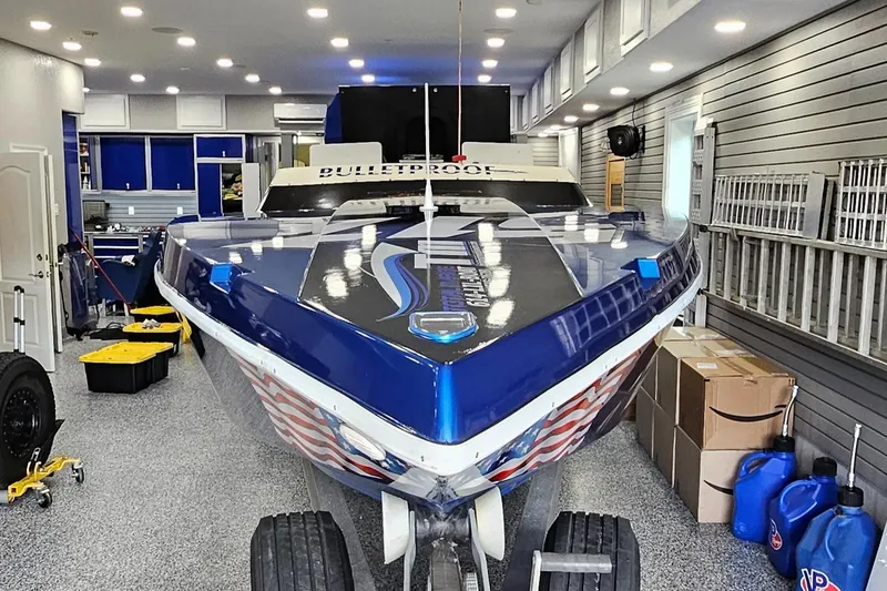Slide: The Image of 2003 Ultimate Warlock 29 World Class Offshore Race boat in a well-lit garage. - 45