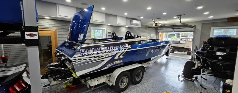 Slide: The Image of 2003 Ultimate Warlock 29 World Class Offshore Race boat in a garage. - 5