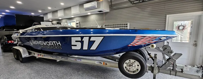 Slide: The Image of Blue 2003 Ultimate Warlock 29 World Class Offshore Race boat on trailer in garage. - 7
