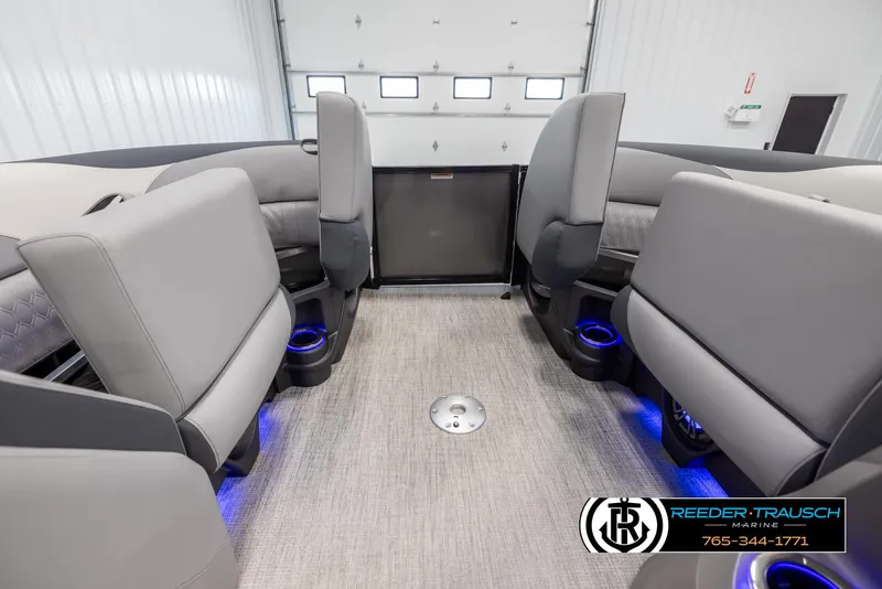 Slide: The Image of Interior of 2025 Avalon LSZ Vrl boat with gray seating and blue LED lighting. - 19