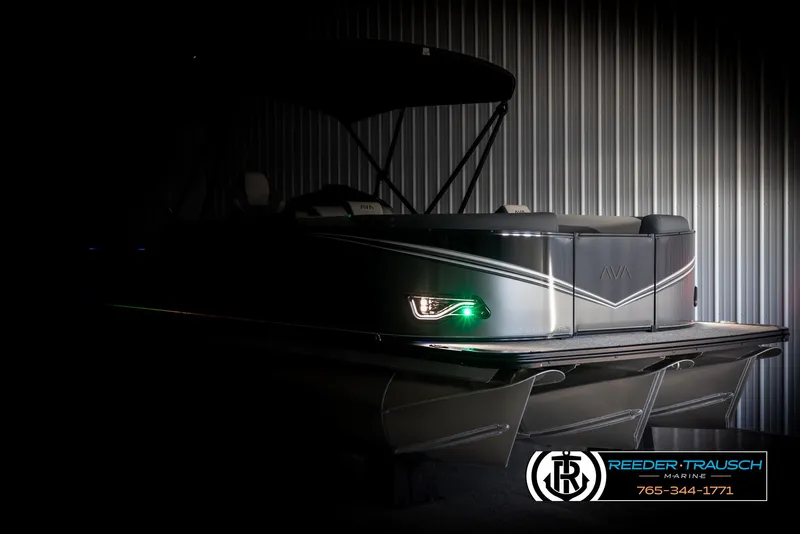 Slide: The Image of 2025 Avalon LSZ Vrl pontoon boat in dimly lit storage, showcasing sleek design. - 4