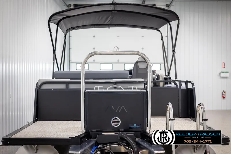 Slide: The Image of 2025 Avalon LSZ Vrl boat in showroom, rear view with canopy and seating. - 7