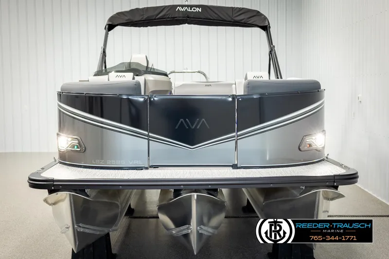 Slide: The Image of 2025 Avalon LSZ Vrl pontoon boat, sleek design, front view in showroom. - 8
