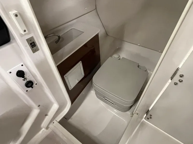 Slide: The Image of 2015 Scarab 255 HO Impulse boat interior with compact bathroom and sink. - 19