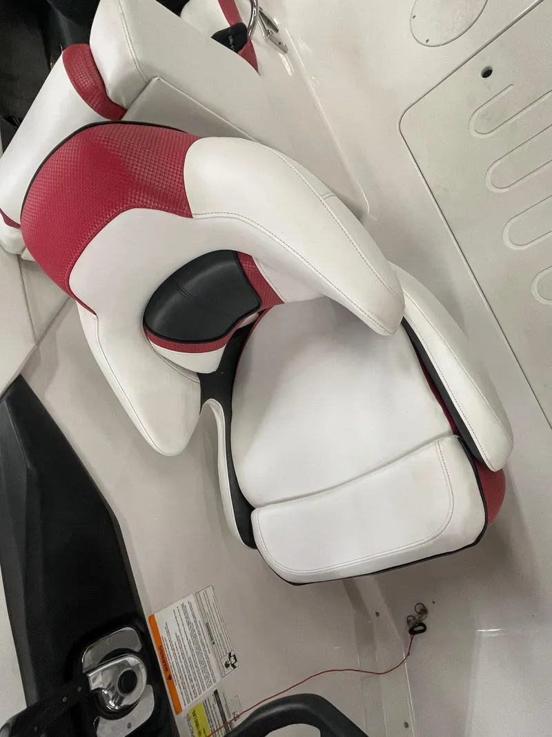Slide: The Image of White and red seat in 2015 Scarab 255 HO Impulse boat interior. - 23