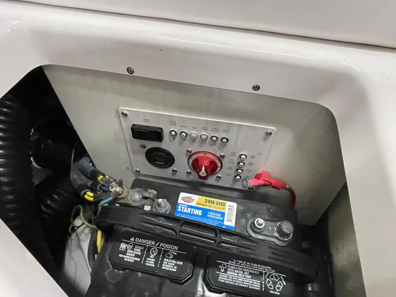 Slide: The Image of 2015 Scarab 255 HO Impulse battery compartment with control panel and wiring. - 25