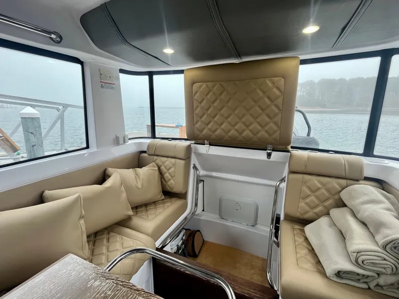 Slide: The Image of Luxurious interior of 2021 Axopar 37 Cabin with wet bar, featuring plush seating and scenic views. - 11