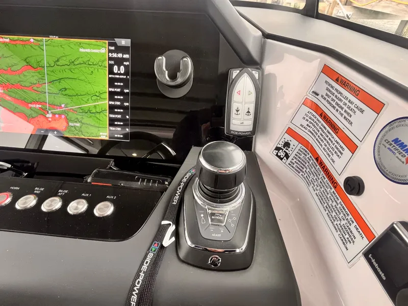 Slide: The Image of Control panel of 2021 Axopar 37 Cabin with navigation display and joystick controls. - 14