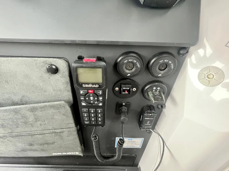 Slide: The Image of Control panel of 2021 Axopar 37 Cabin with Simrad radio and switches. - 16