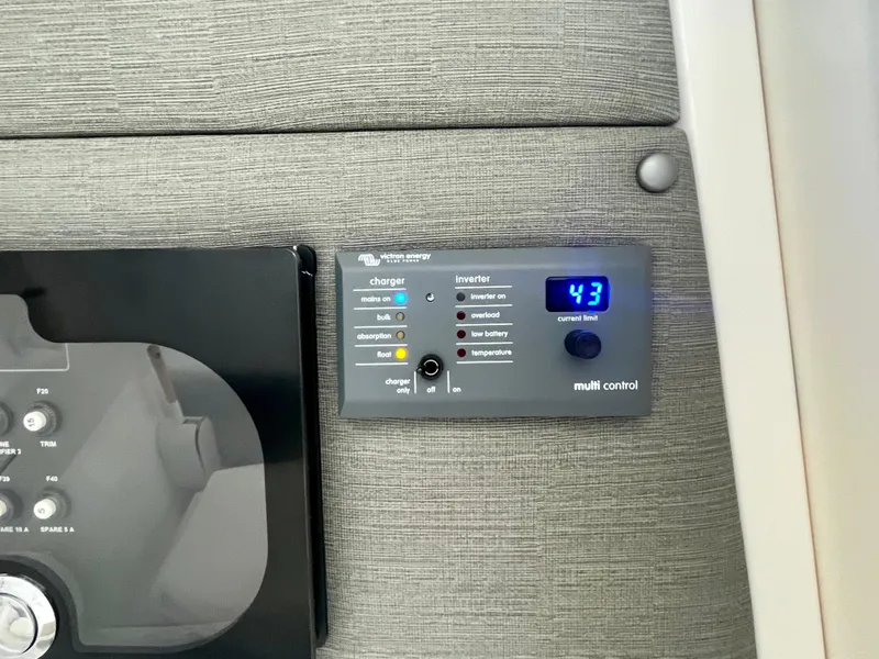 Slide: The Image of Control panel in 2021 Axopar 37 Cabin with wet bar, displaying digital readout. - 17