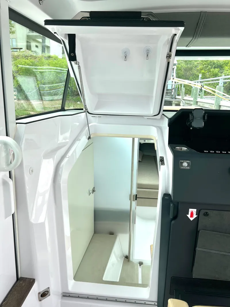 Slide: The Image of 2021 Axopar 37 XC Cross Cabin interior with open storage and wet bar. - 18