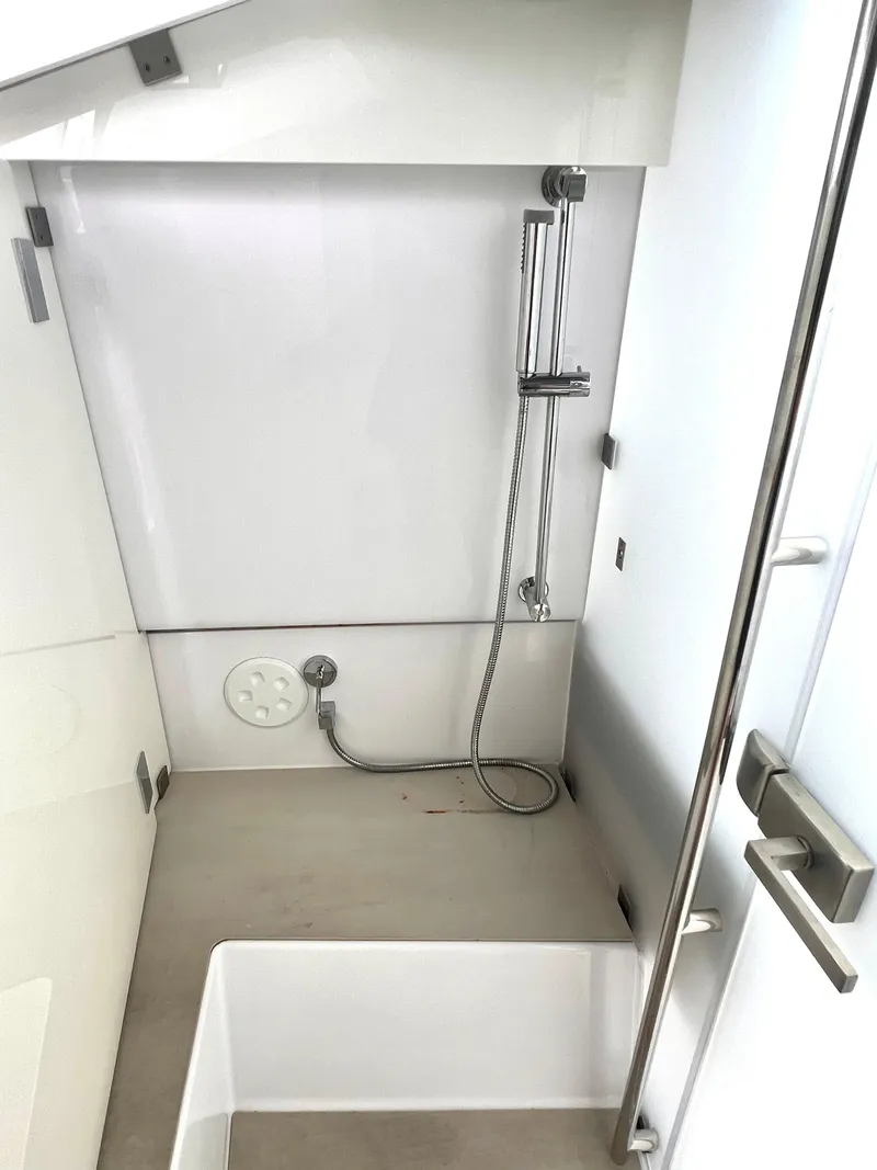 Slide: The Image of 2021 Axopar 37 XC Cross Cabin shower area with modern fixtures and sleek design. - 19