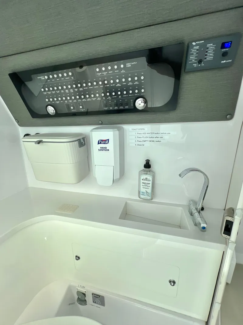 Slide: The Image of 2021 Axopar 37 XC Cross Cabin wet bar with control panel and sink. - 21