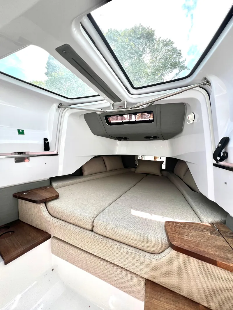 Slide: The Image of 2021 Axopar 37 XC Cross Cabin interior with skylight and comfortable seating. - 23