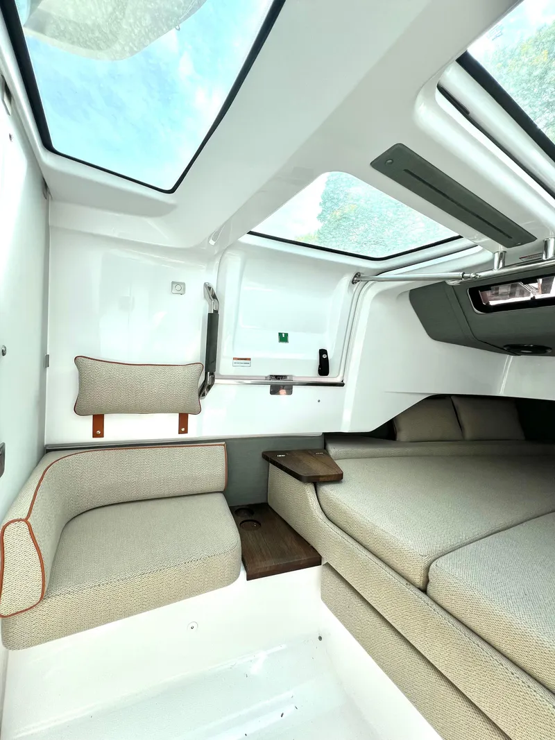 Slide: The Image of 2021 Axopar 37 XC Cross Cabin interior with seating and skylights. - 24