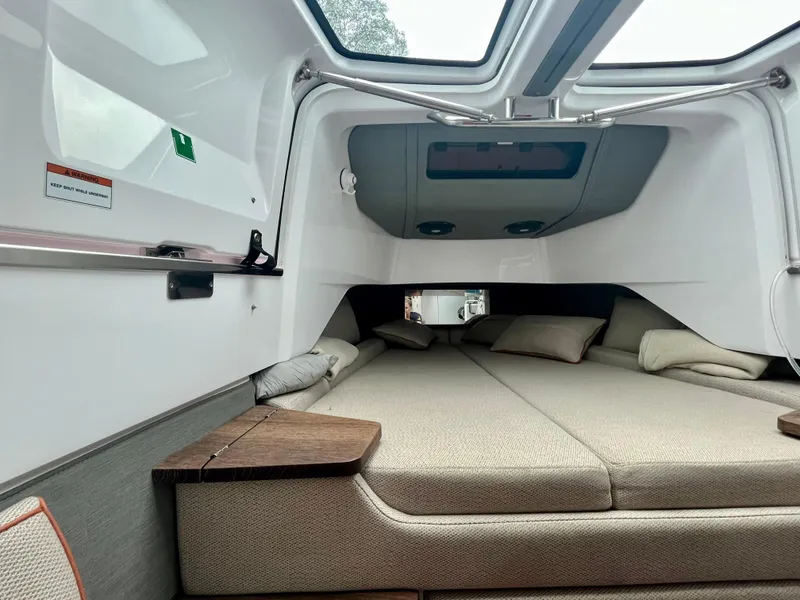 Slide: The Image of 2021 Axopar 37 Cabin interior with cozy bed and modern design. - 25