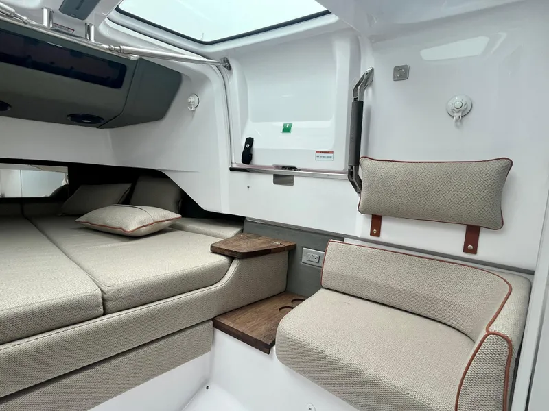 Slide: The Image of 2021 Axopar 37 Cabin interior with seating and bedding, featuring modern design and comfort. - 26