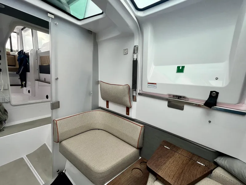 Slide: The Image of 2021 Axopar 37 Cabin interior with seating and wet bar area. - 28