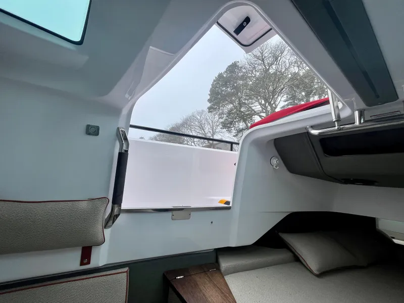 Slide: The Image of Interior view of 2021 Axopar 37 Cabin with wet bar, featuring modern design and comfortable seating. - 29