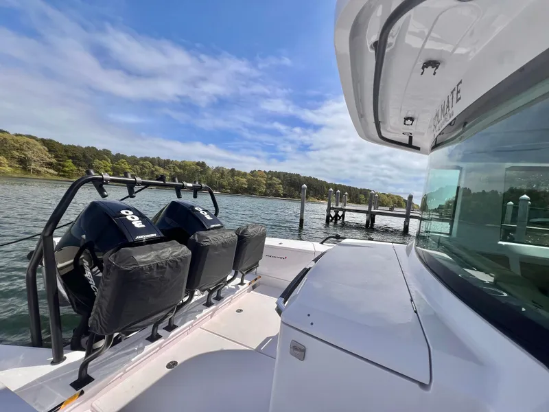 Slide: The Image of 2021 Axopar 37 XC Cross Cabin with wet bar, docked by scenic waterfront. - 32