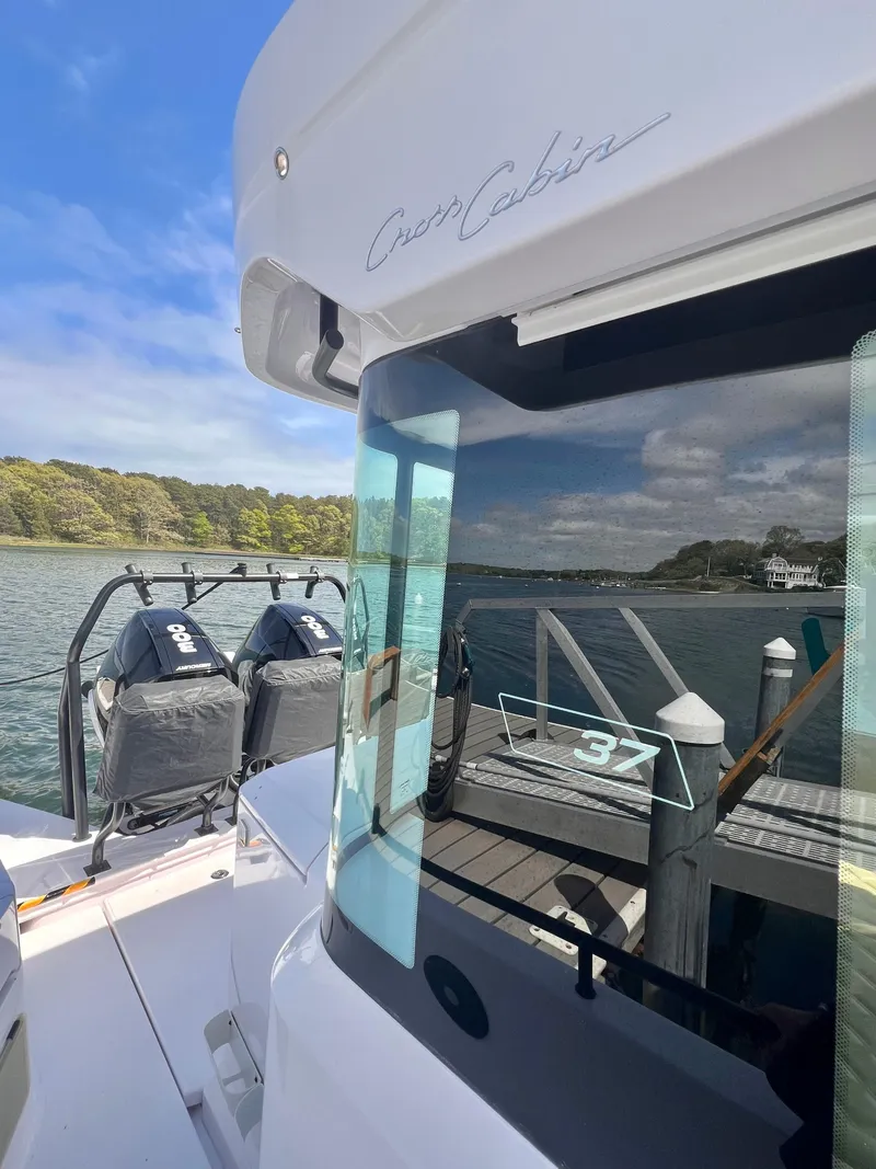 Slide: The Image of 2021 Axopar 37 XC Cross Cabin with wet bar, docked by scenic waterfront. - 35