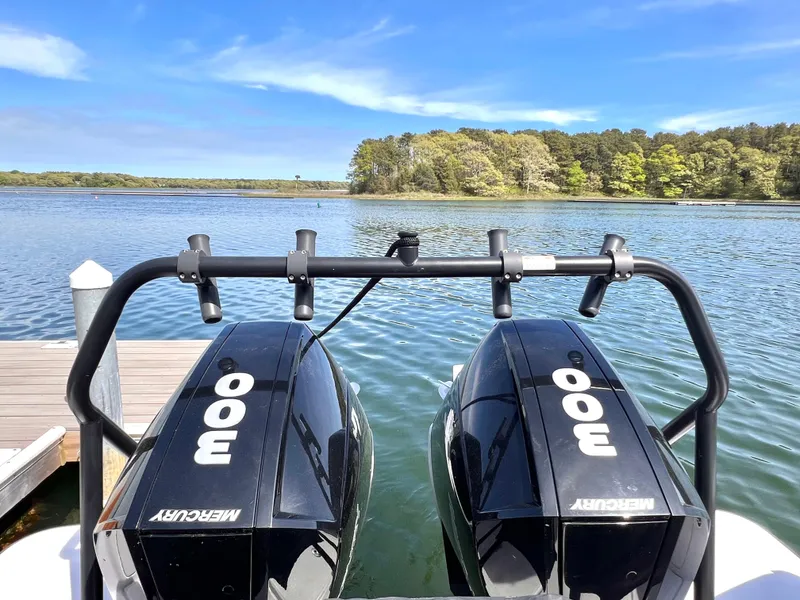 Slide: The Image of 2021 Axopar 37 XC Cross Cabin with twin Mercury 300 engines on a serene lake. - 36