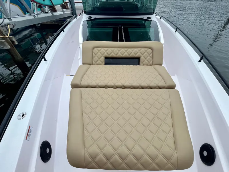 Slide: The Image of 2021 Axopar 37 Cabin with Wet Bar, featuring luxurious tan quilted seating. - 39