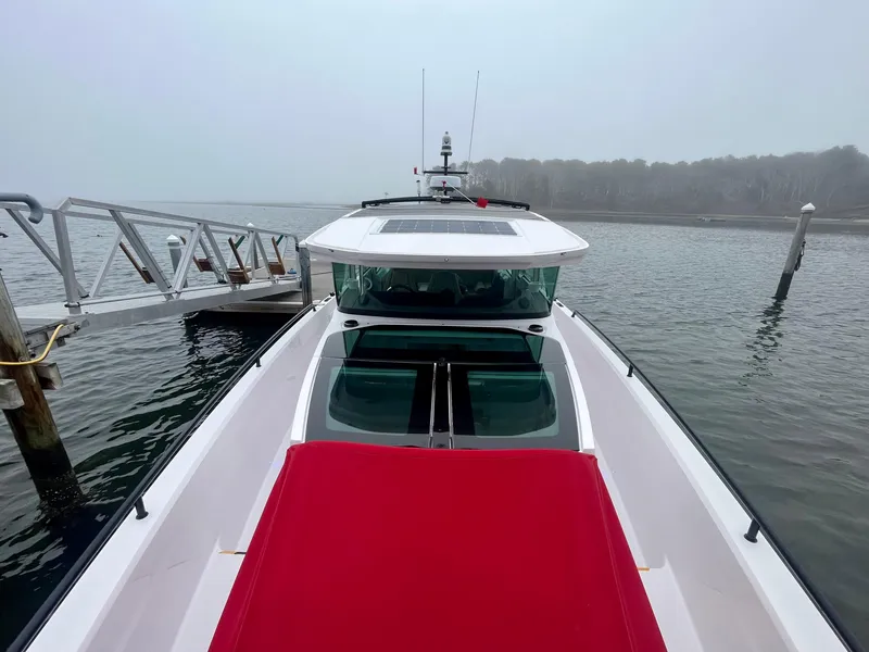 Slide: The Image of 2021 Axopar 37 Cabin with Wet Bar, docked on a misty day. - 42