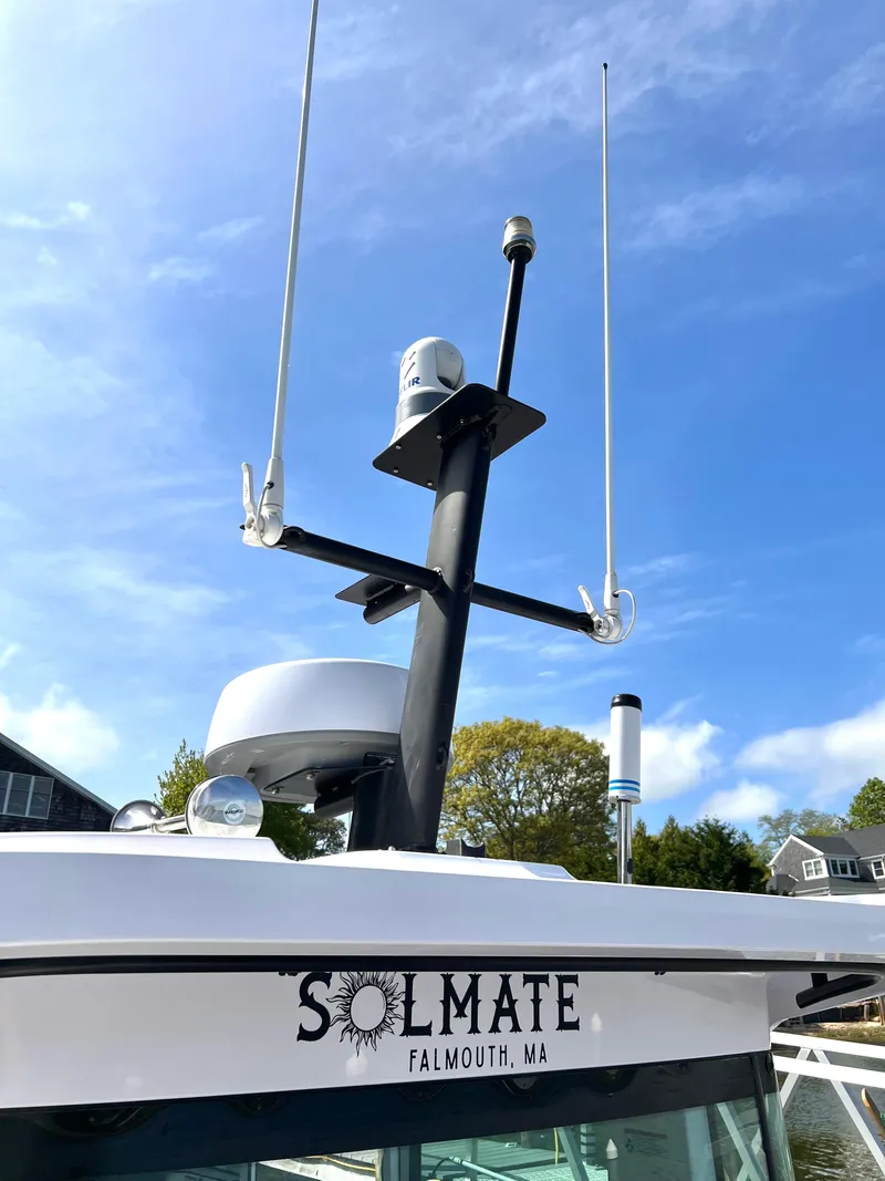 Slide: The Image of 2021 Axopar 37 XC Cross Cabin with antennas and radar, docked in Falmouth, MA. - 43