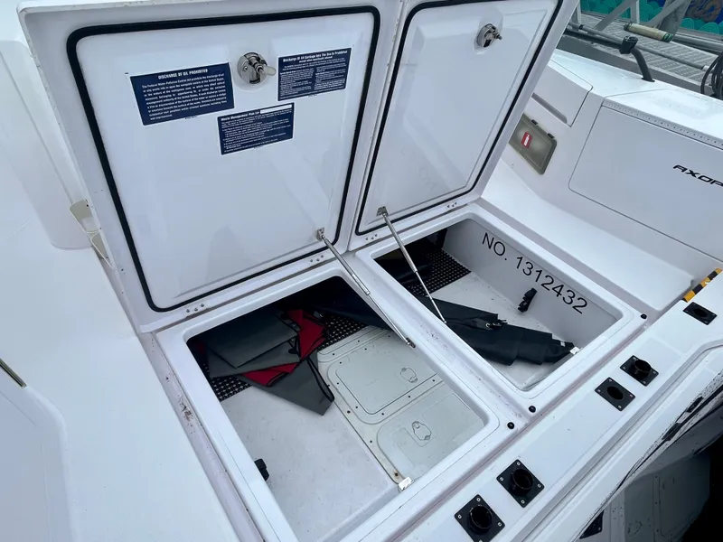 Slide: The Image of 2021 Axopar 37 Cabin Wet Bar storage compartments open, showing interior details. - 46