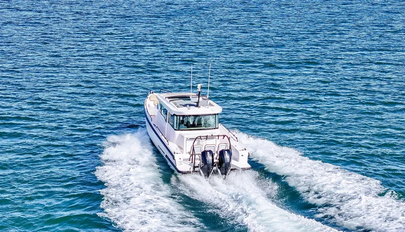 Slide: The Image of 2021 Axopar 37 Cabin with Wet Bar cruising on open water. - 49