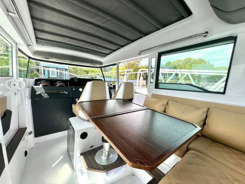 Slide: The Image of Interior of 2021 Axopar 37 XC Cross Cabin with wet bar, featuring seating and table. - 7