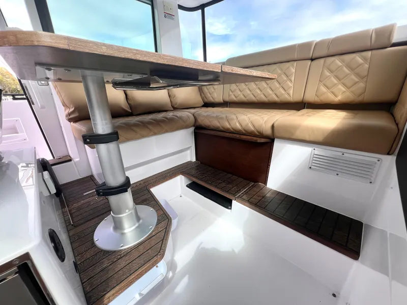 Slide: The Image of Luxurious interior of 2021 Axopar 37 XC Cross Cabin with wet bar and plush seating. - 8