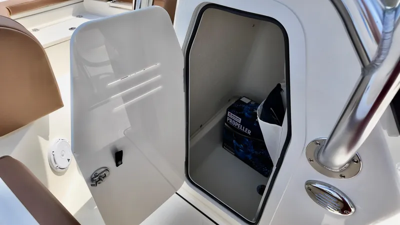 Slide: The Image of Open storage compartment on 2025 Pioneer 220 Bay Sport boat with propeller box inside. - 12