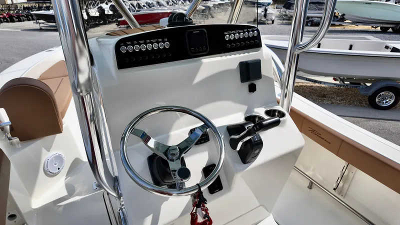 Slide: The Image of 2025 Pioneer 220 Bay Sport boat console with steering wheel and controls. - 13