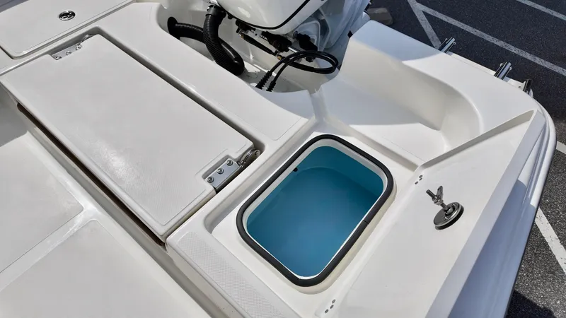 Slide: The Image of 2025 Pioneer 220 Bay Sport boat deck with storage compartments and livewell. - 16